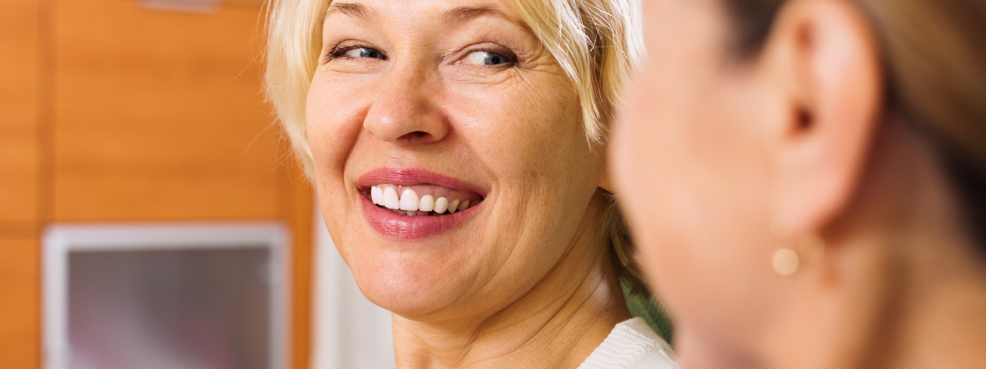 Picture of woman smiling while talking to another person